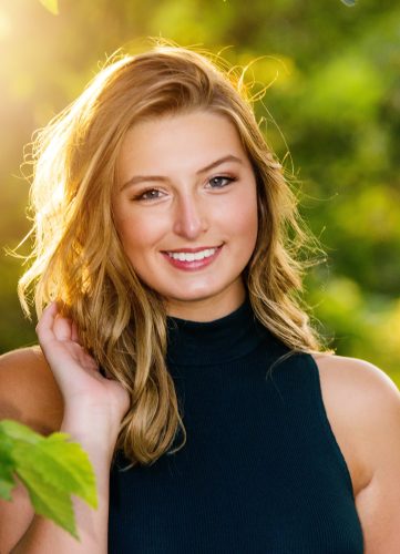 Sunny backlit photo of ahigh school senior girl at Olbrich Botanical Gardens in Madison, WI
